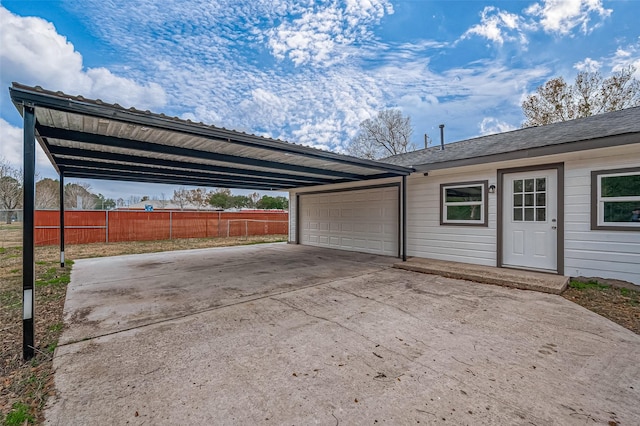 103 Anna St, Tomball, TX 77375 - garage with fence, driveway, and an attached carport