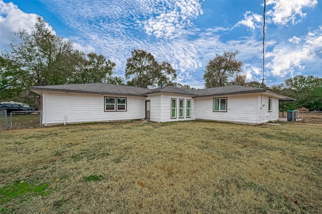 103 Anna St, Tomball, TX 77375 - rear view of house featuring a lawn