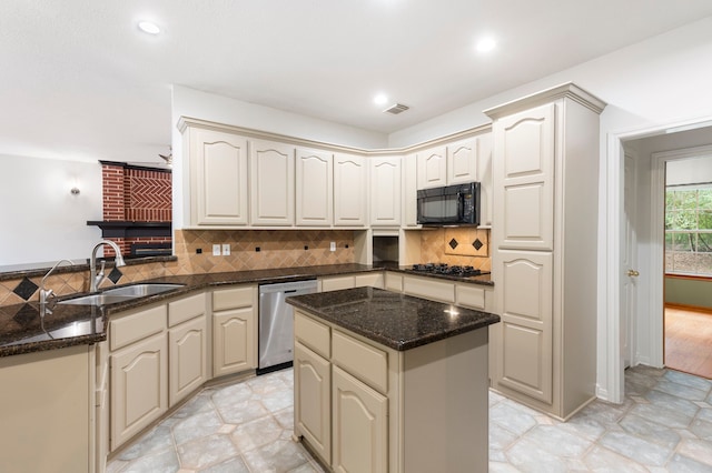 19906 Bayberry Creek Dr, Magnolia, TX 77355 - kitchen with black appliances, a peninsula, a sink, cream cabinets, and recessed lighting