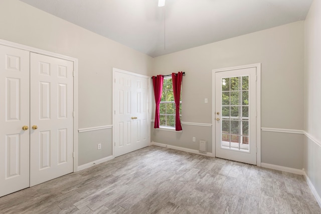 19906 Bayberry Creek Dr, Magnolia, TX 77355 - unfurnished bedroom featuring two closets, wood finished floors, access to exterior, and baseboards