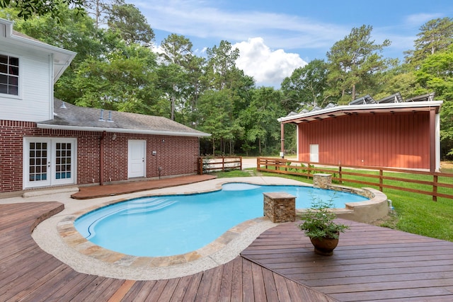19906 Bayberry Creek Dr, Magnolia, TX 77355 - view of swimming pool featuring a wooden deck, french doors, and view of scattered trees
