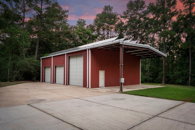 19906 Bayberry Creek Dr, Magnolia, TX 77355 - garage at dusk with a yard and a garage