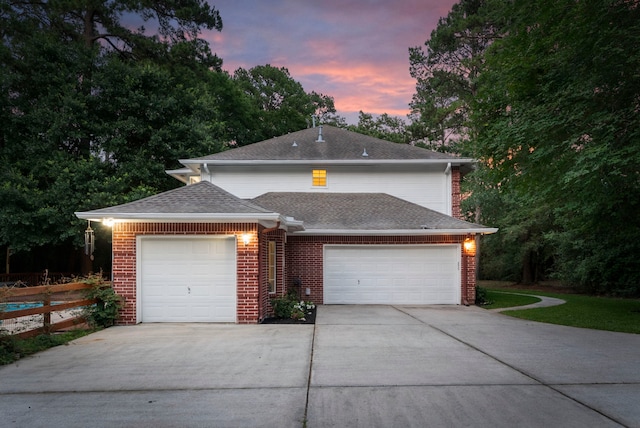 19906 Bayberry Creek Dr, Magnolia, TX 77355 - view of front of house with driveway, brick siding, a garage, and a shingled roof
