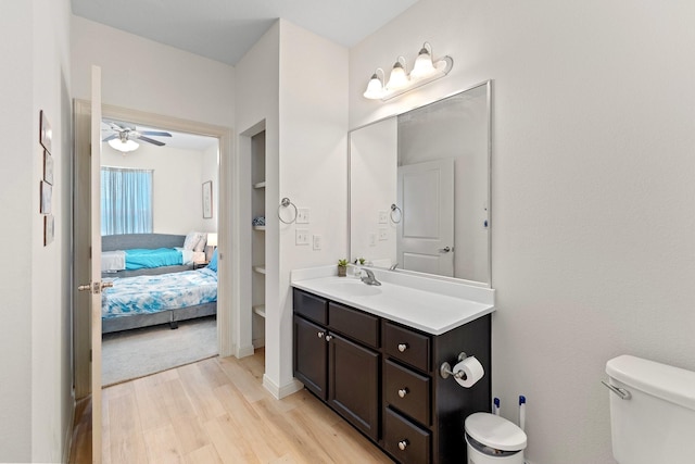 2107 54th St, Galveston, TX 77551 - ensuite bathroom featuring toilet, wood finished floors, a ceiling fan, vanity, and built in features
