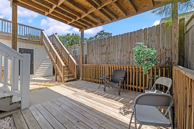 2107 54th St, Galveston, TX 77551 - wooden terrace with stairway and fence