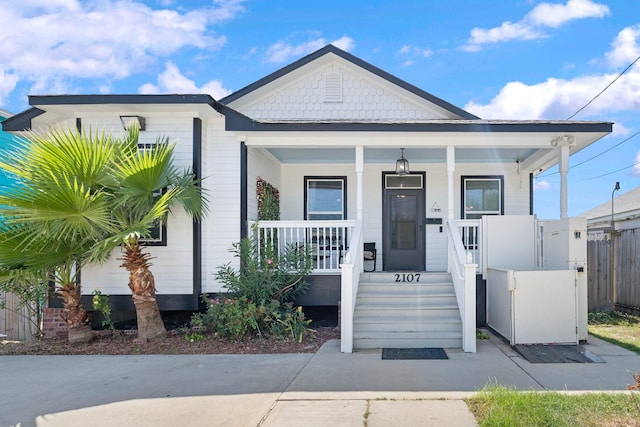 2107 54th St, Galveston, TX 77551 - view of front of property featuring covered porch and fence