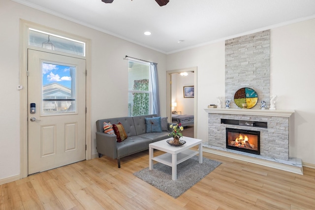 2107 54th St, Galveston, TX 77551 - living room featuring wood finished floors, a ceiling fan, ornamental molding, a stone fireplace, and recessed lighting