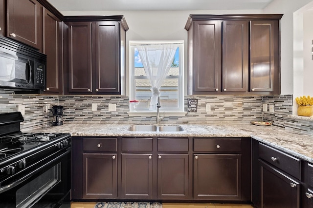 2107 54th St, Galveston, TX 77551 - kitchen with black appliances, a sink, dark brown cabinets, backsplash, and light stone countertops
