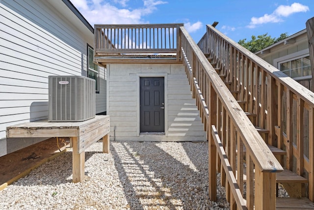 2107 54th St, Galveston, TX 77551 - property entrance with central AC unit and a deck