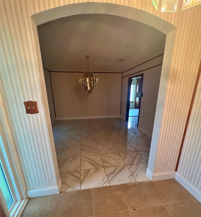 3811 Empress Ln, Richmond, TX 77406 - unfurnished dining area with arched walkways, baseboards, a chandelier, and wallpapered walls