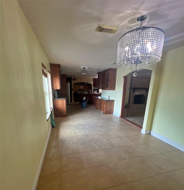 3811 Empress Ln, Richmond, TX 77406 - unfurnished living room with a chandelier, light tile patterned flooring, and baseboards