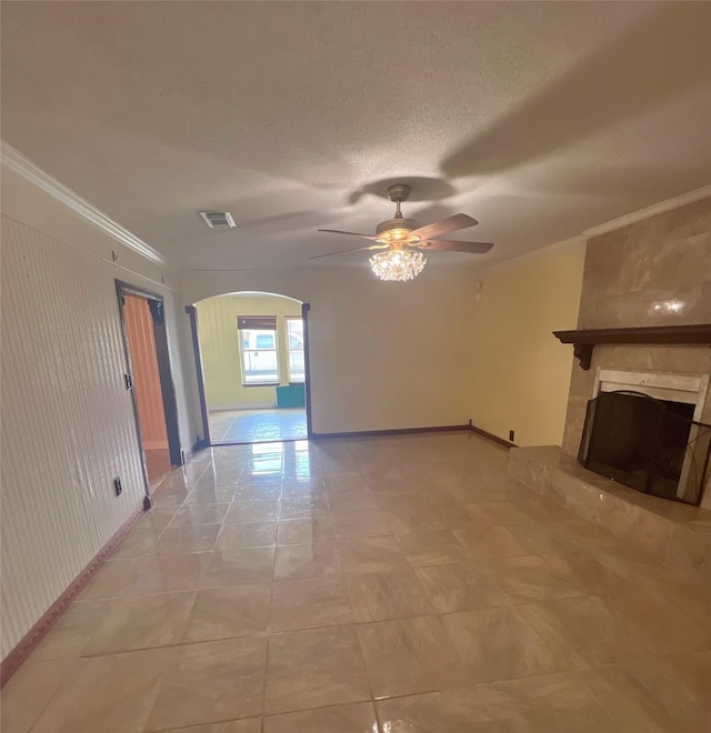 3811 Empress Ln, Richmond, TX 77406 - unfurnished living room with arched walkways, baseboards, ceiling fan, a large fireplace, and ornamental molding