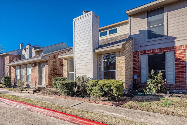 9393 Westwood Village Dr Unit 64, Houston, TX 77036 - view of front of property featuring a chimney and brick siding