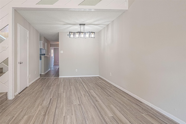 9393 Westwood Village Dr Unit 64, Houston, TX 77036 - unfurnished dining area with light wood-style flooring and baseboards