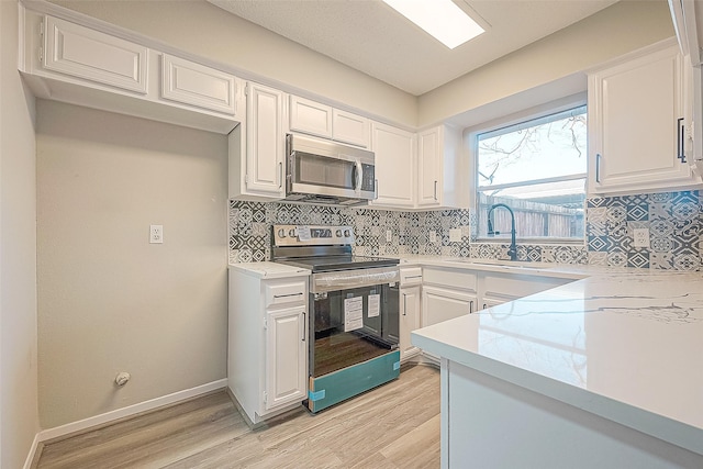 9393 Westwood Village Dr Unit 64, Houston, TX 77036 - kitchen featuring stainless steel appliances, a sink, light countertops, and tasteful backsplash