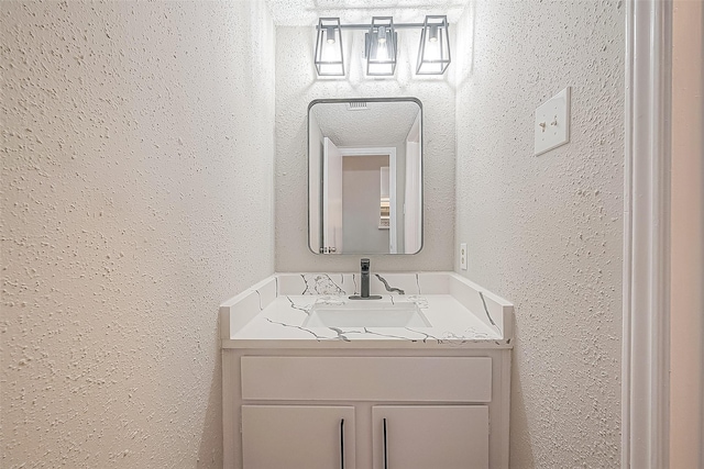 9393 Westwood Village Dr Unit 64, Houston, TX 77036 - bathroom with a textured wall and vanity