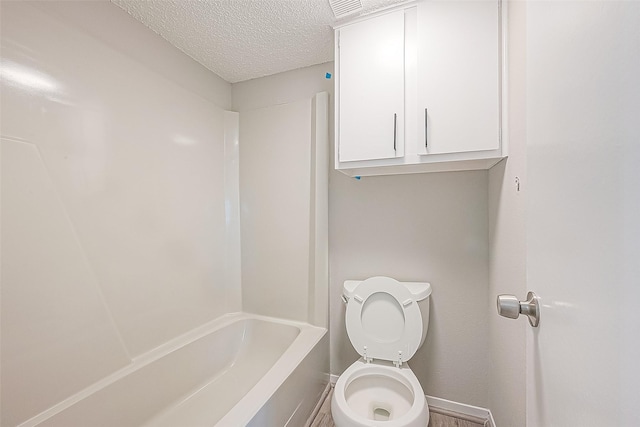 9393 Westwood Village Dr Unit 64, Houston, TX 77036 - bathroom with baseboards, a textured ceiling, and toilet