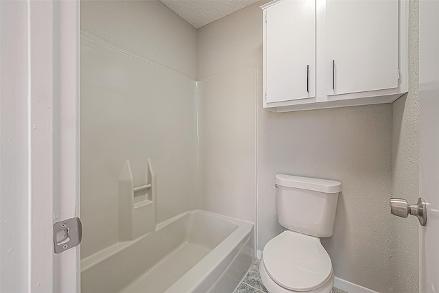 9393 Westwood Village Dr Unit 64, Houston, TX 77036 - bathroom featuring toilet, baseboards, a textured ceiling, and  shower combination