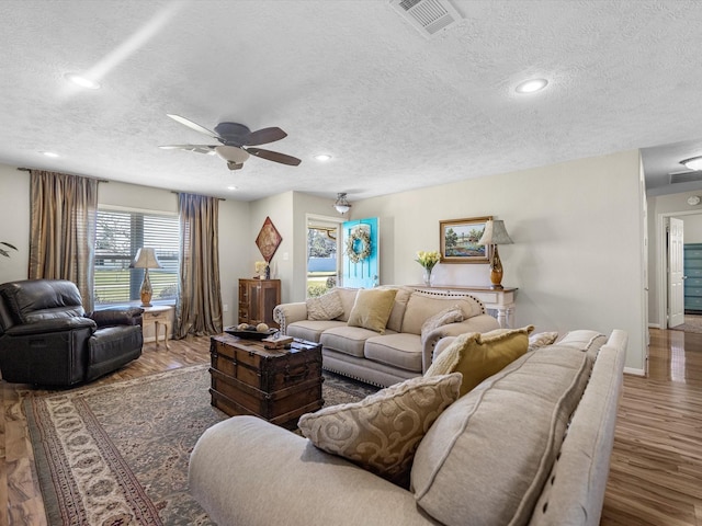 316 N Magnolia St, Highlands, TX 77562 - living room with a textured ceiling, a ceiling fan, wood finished floors, baseboards, and recessed lighting