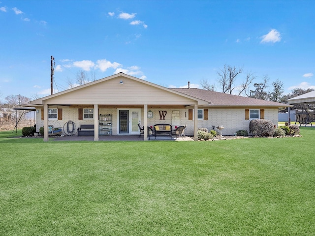 316 N Magnolia St, Highlands, TX 77562 - back of property featuring brick siding and a lawn