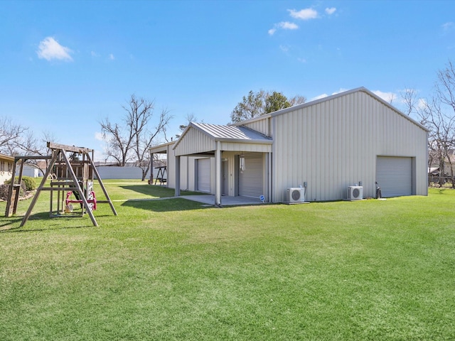 316 N Magnolia St, Highlands, TX 77562 - back of property with a garage, a yard, a playground, and ac unit