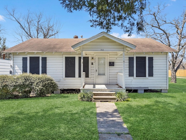 316 N Magnolia St, Highlands, TX 77562 - view of front of home featuring a shingled roof and a front yard