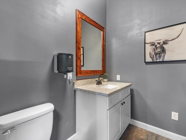 316 N Magnolia St, Highlands, TX 77562 - bathroom featuring toilet, baseboards, vanity, and wood finished floors