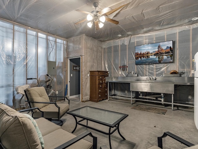 316 N Magnolia St, Highlands, TX 77562 - living room featuring a ceiling fan, concrete flooring, and electric panel