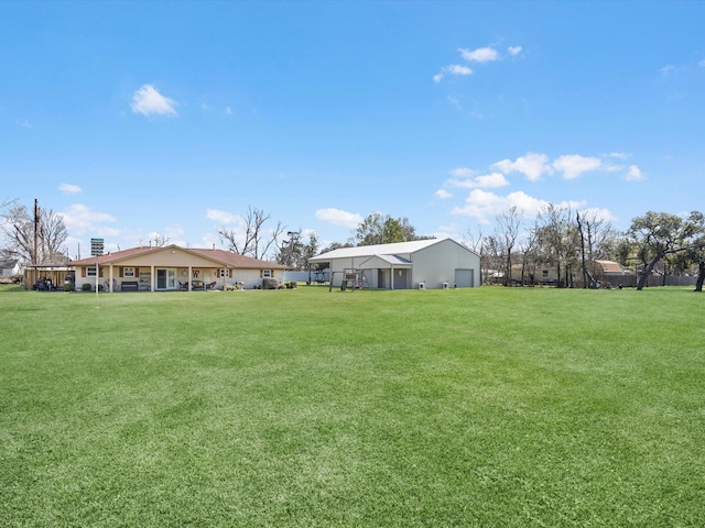 316 N Magnolia St, Highlands, TX 77562 - view of grassy yard featuring a detached garage