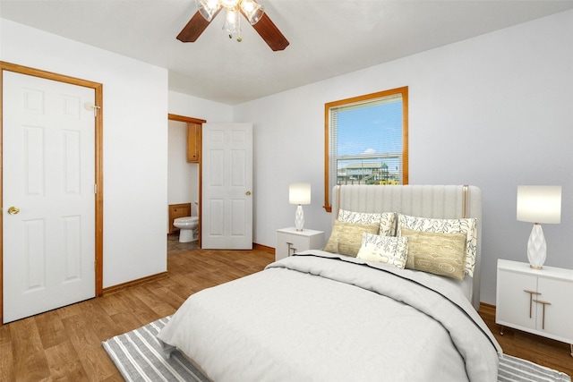 908 W Ln, Crystal Beach, TX 77650 - bedroom featuring wood finished floors, baseboards, ensuite bathroom, and a ceiling fan