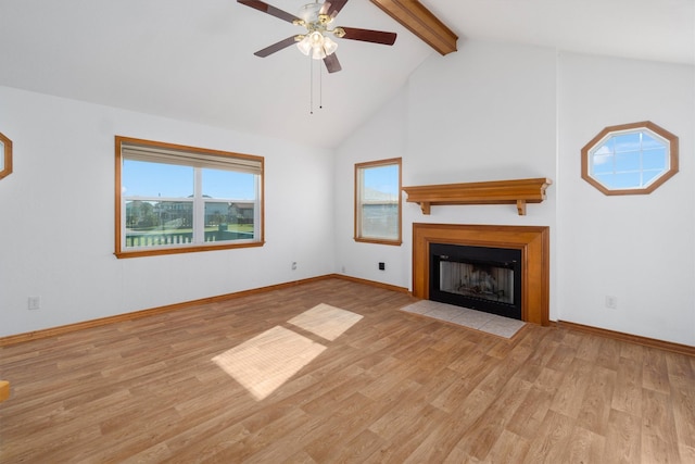 908 W Ln, Crystal Beach, TX 77650 - unfurnished living room featuring beamed ceiling, plenty of natural light, ceiling fan, wood finished floors, and a fireplace with flush hearth
