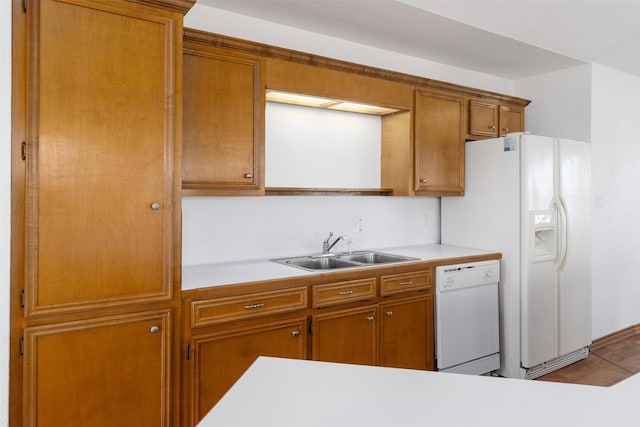 908 W Ln, Crystal Beach, TX 77650 - kitchen with white appliances, a sink, light countertops, and brown cabinets