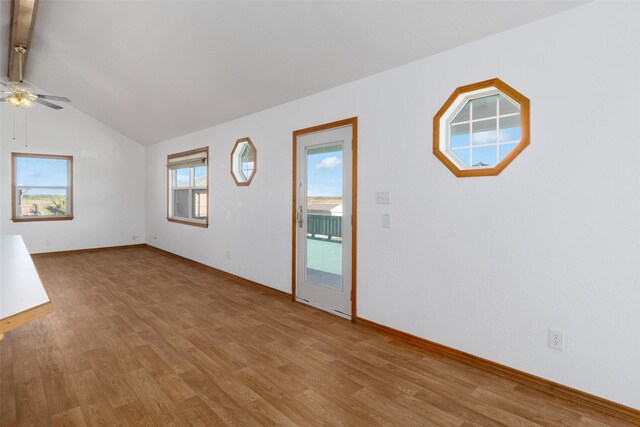 908 W Ln, Crystal Beach, TX 77650 - unfurnished living room with ceiling fan, light wood-style flooring, lofted ceiling, and baseboards