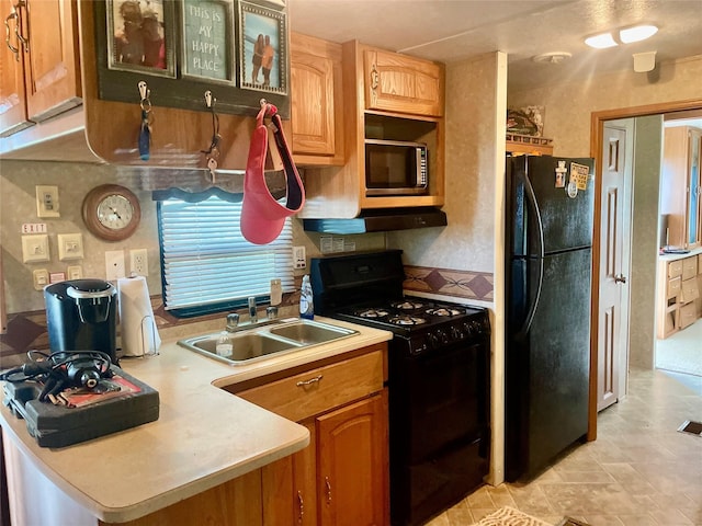 1139 Diamond Rd, Crystal Beach, TX 77650 - kitchen featuring black appliances, a sink, and light countertops