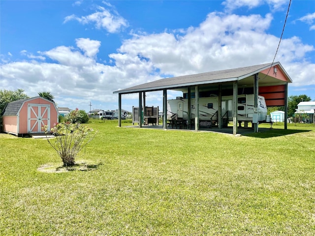 1139 Diamond Rd, Crystal Beach, TX 77650 - view of grassy yard with a storage unit, an outdoor structure, and a carport