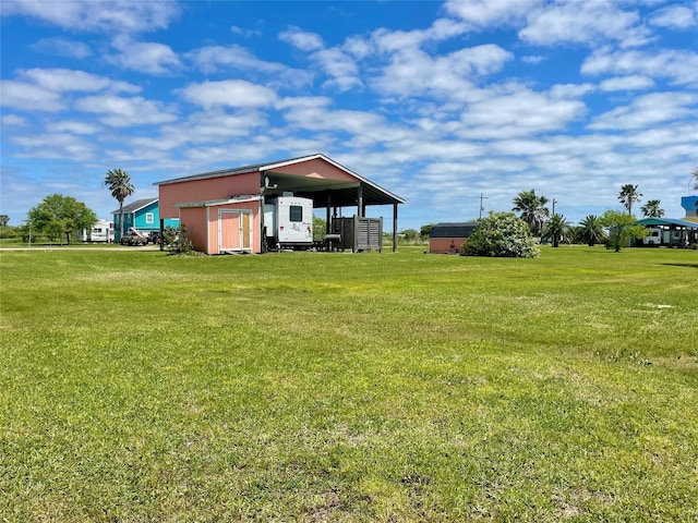 1139 Diamond Rd, Crystal Beach, TX 77650 - view of green lawn featuring an outbuilding and a pole building