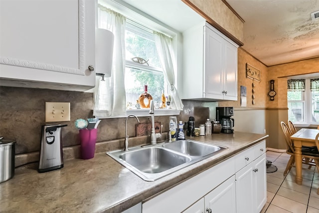 711 Seacliff Dr, Houston, TX 77062 - kitchen featuring a sink, white cabinets, and light tile patterned flooring