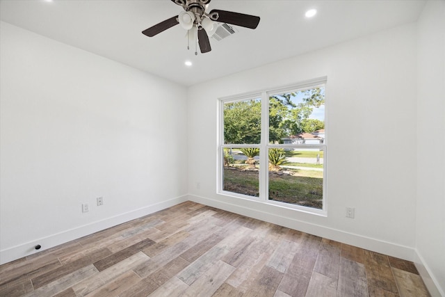 spare room with baseboards, a ceiling fan, wood finished floors, and recessed lighting