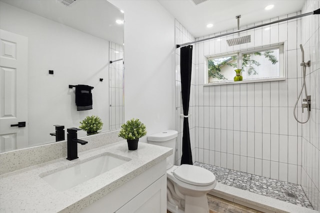 full bath featuring toilet, a stall shower, vanity, and recessed lighting