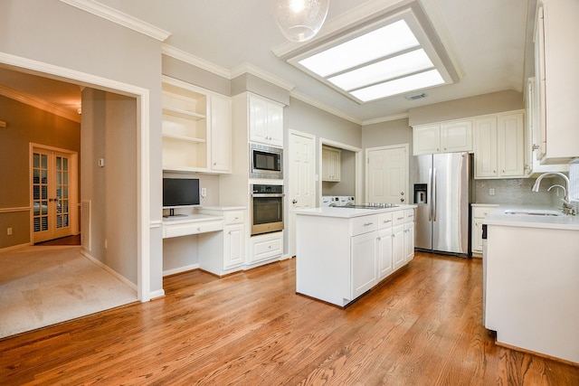 13702 Senca Park Dr, Houston, TX 77077 - kitchen with appliances with stainless steel finishes, a sink, open shelves, a center island, and white cabinetry