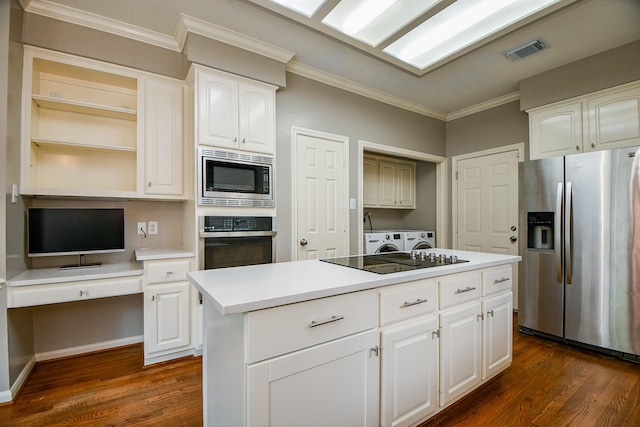 13702 Senca Park Dr, Houston, TX 77077 - kitchen with appliances with stainless steel finishes, washing machine and dryer, ornamental molding, dark wood-type flooring, and a center island