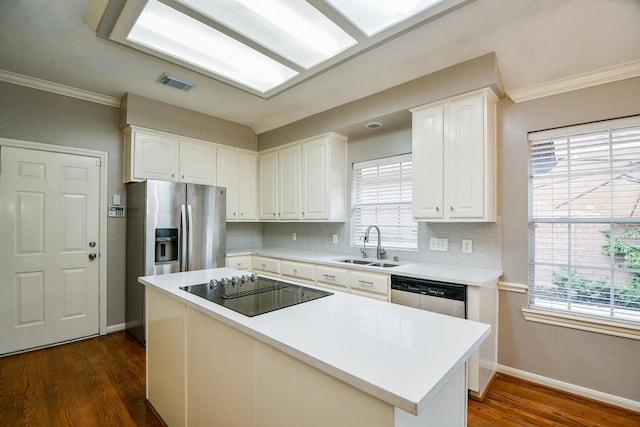 13702 Senca Park Dr, Houston, TX 77077 - kitchen featuring appliances with stainless steel finishes, a sink, white cabinets, dark wood-type flooring, and crown molding