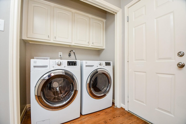 13702 Senca Park Dr, Houston, TX 77077 - clothes washing area featuring independent washer and dryer, light wood finished floors, cabinet space, and baseboards