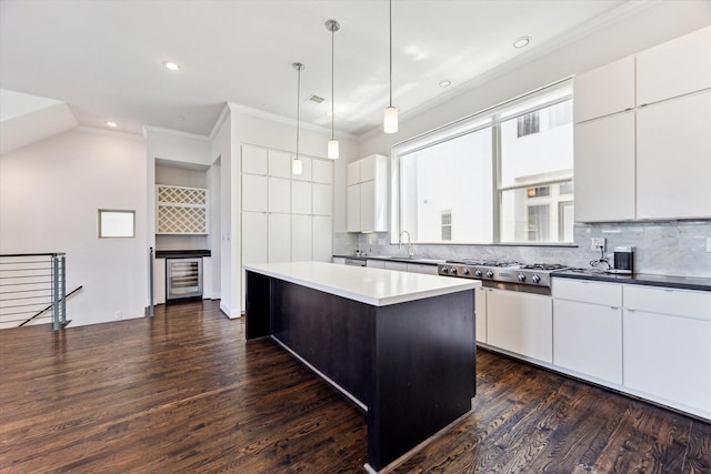 1505 Missouri St, Houston, TX 77006 - kitchen with beverage cooler, a sink, backsplash, ornamental molding, and dark wood finished floors