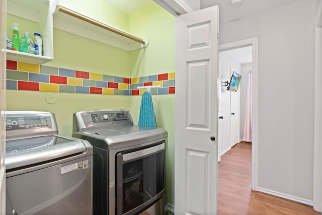 19030 Piney Way Dr, Tomball, TX 77375 - laundry area with washing machine and clothes dryer, wood finished floors, and baseboards