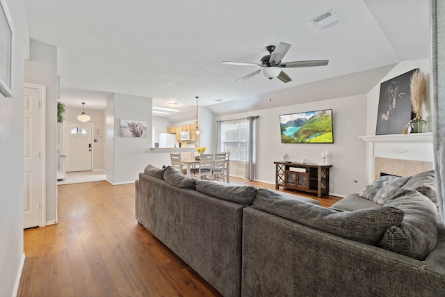 19030 Piney Way Dr, Tomball, TX 77375 - living room featuring ceiling fan, wood finished floors, baseboards, and a fireplace