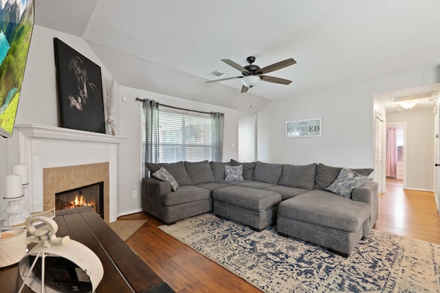 19030 Piney Way Dr, Tomball, TX 77375 - living area featuring wood finished floors, ceiling fan, a tile fireplace, and baseboards