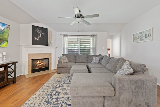 19030 Piney Way Dr, Tomball, TX 77375 - living area featuring wood finished floors, a tiled fireplace, a ceiling fan, and vaulted ceiling