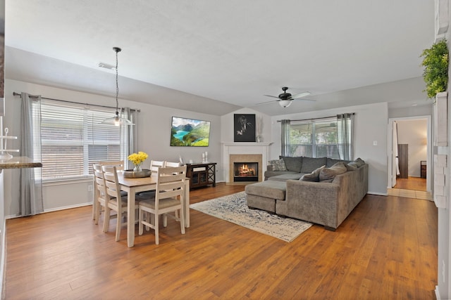 19030 Piney Way Dr, Tomball, TX 77375 - dining area featuring ceiling fan, wood finished floors, a lit fireplace, and baseboards