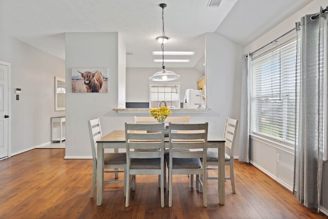 19030 Piney Way Dr, Tomball, TX 77375 - dining space with lofted ceiling, wood finished floors, and baseboards